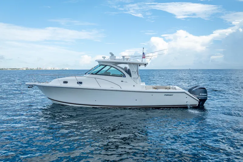 Slide: The Image of 2011 Pursuit OS 345 Offshore boat on open water under blue sky. - 7