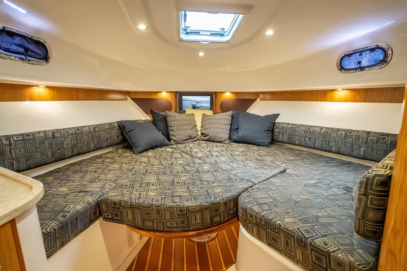 Slide: The Image of Luxurious cabin interior of 2011 Pursuit OS 345 Offshore boat with cozy seating and cushions. - 70