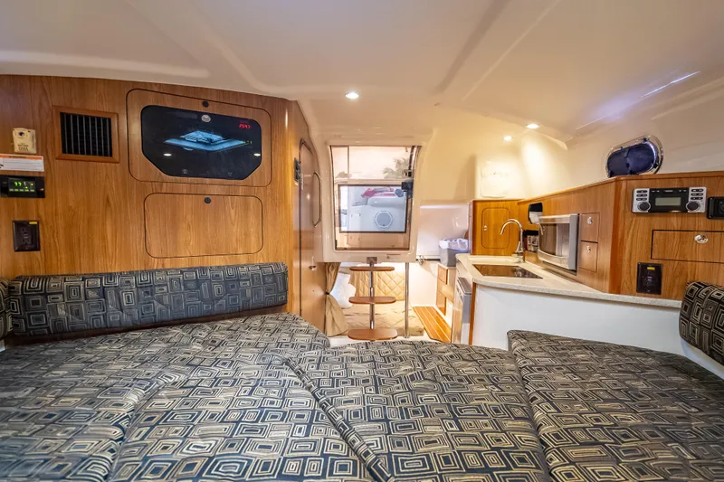Slide: The Image of Interior of 2011 Pursuit OS 345 Offshore boat with cozy seating and kitchenette. - 71