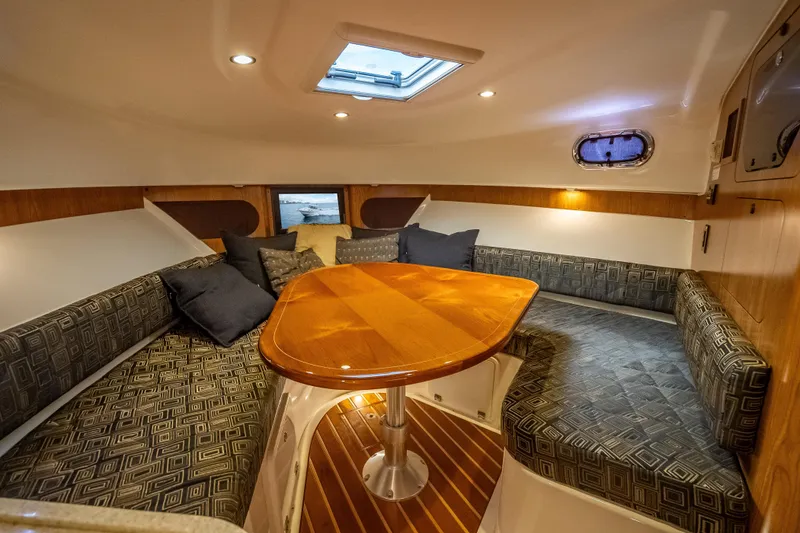 Slide: The Image of Luxurious interior of 2011 Pursuit OS 345 Offshore boat with elegant seating and wooden table. - 76