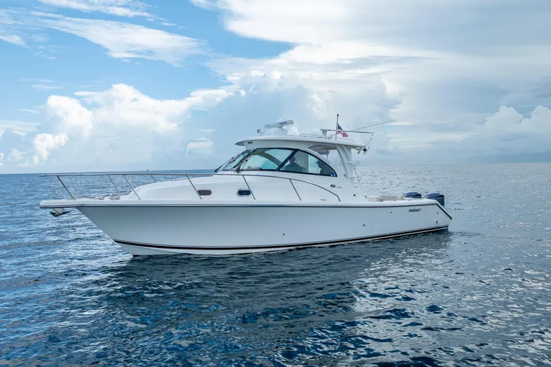 Slide: The Image of 2011 Pursuit OS 345 Offshore boat on calm ocean under cloudy sky. - 8
