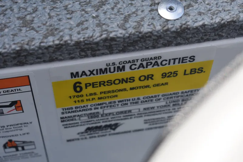 Slide: The Image of 2026 Lund 1800 Explorer SS boat interior with storage compartment and seating. - 11