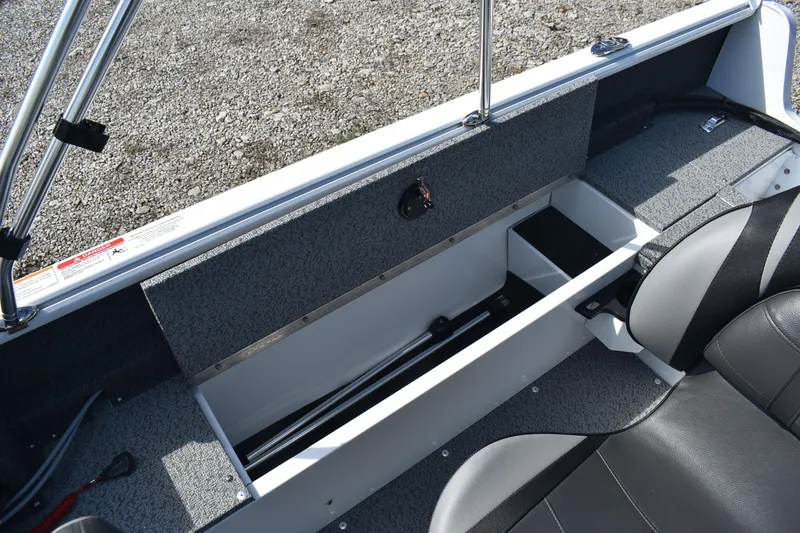 Slide: The Image of 2026 Lund 1800 Explorer SS boat interior with storage compartments and Mercury Pro XS engine. - 12