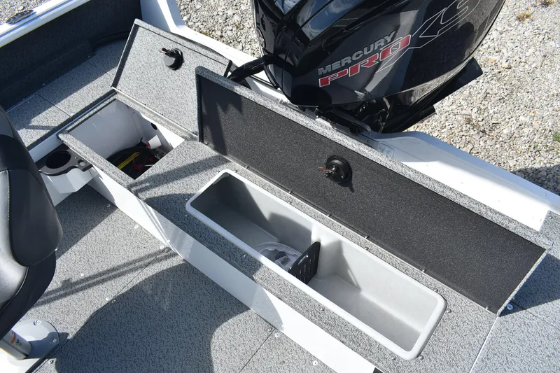 Slide: The Image of 2026 Lund 1800 Explorer SS boat interior with open storage compartment. - 13
