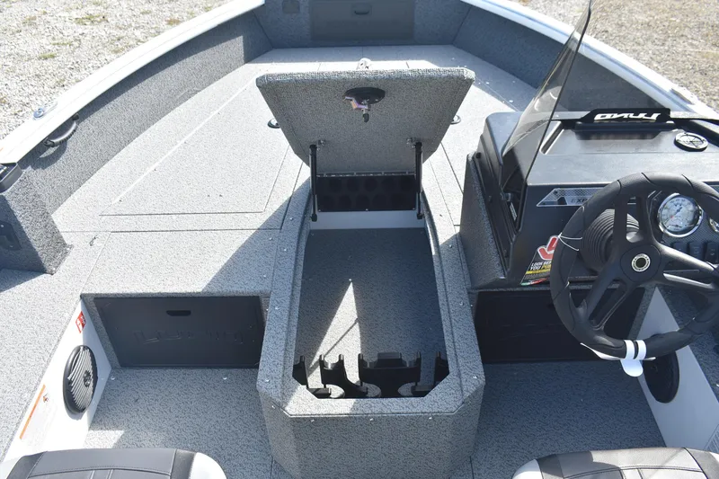 Slide: The Image of 2026 Lund 1800 Explorer SS boat with open storage compartment on gravel surface. - 17