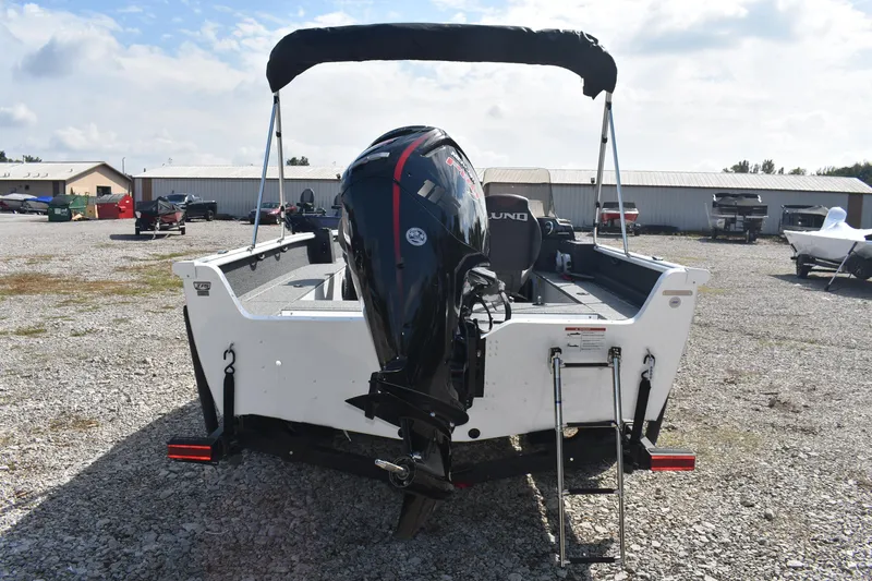 Slide: The Image of 2026 Lund 1800 Explorer SS boat with Mercury Pro XS outboard motor, parked on gravel. - 6