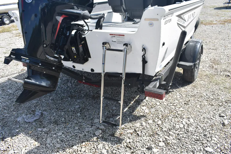 Slide: The Image of 2026 Lund 1800 Explorer SS boat interior with steering console and seating. - 8