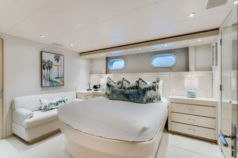 Slide: The Image of Luxurious bedroom in 2001 Westship Skylounge yacht with elegant decor and porthole windows. - 29