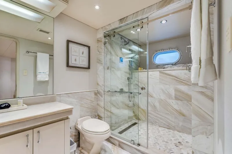 Slide: The Image of Luxurious bathroom in 2001 Westship Skylounge yacht with marble shower and porthole window. - 31