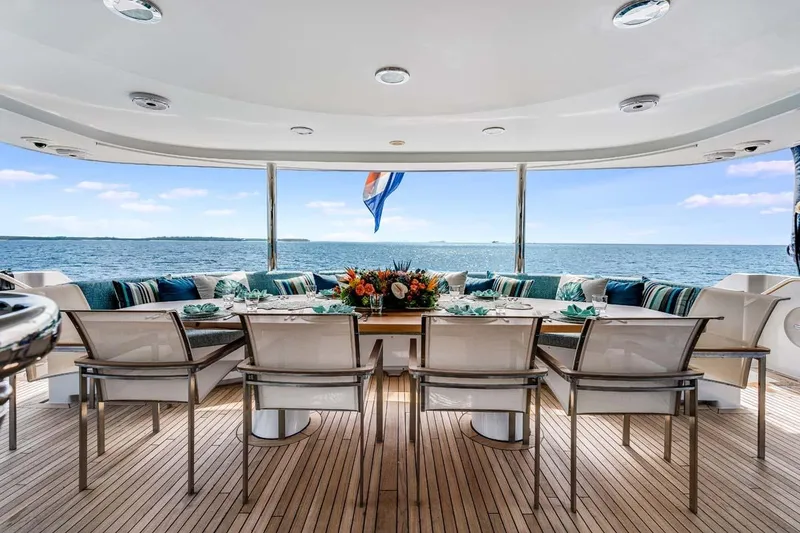 Slide: The Image of Luxurious 2001 Westship Skylounge yacht deck with elegant dining setup and ocean view. - 4