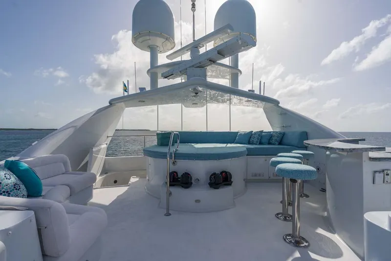 Slide: The Image of Luxurious 2001 Westship Skylounge yacht deck with seating, bar stools, and ocean view. - 50