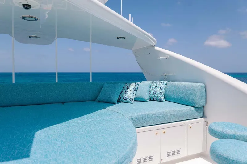 Slide: The Image of Luxurious 2001 Westship Skylounge yacht with turquoise seating, ocean view, and clear blue sky. - 54