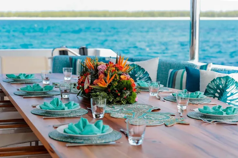 Slide: The Image of Elegant dining setup on 2001 Westship Skylounge yacht with ocean view and floral centerpiece. - 6