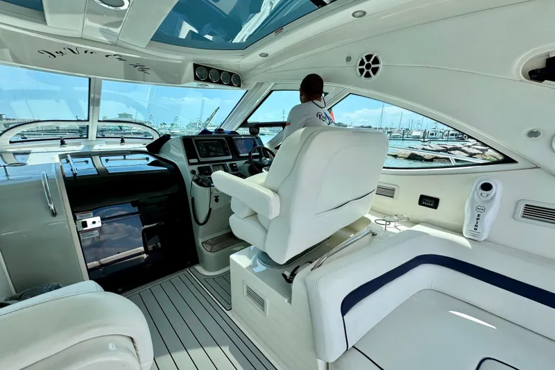 Slide: The Image of Interior of 2009 Sea Ray 470 Sundancer yacht with modern helm and seating. - 10