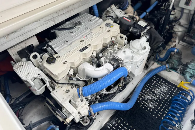 Slide: The Image of Engine compartment of a 2009 Sea Ray 470 Sundancer with Cummins engine and blue hoses. - 11