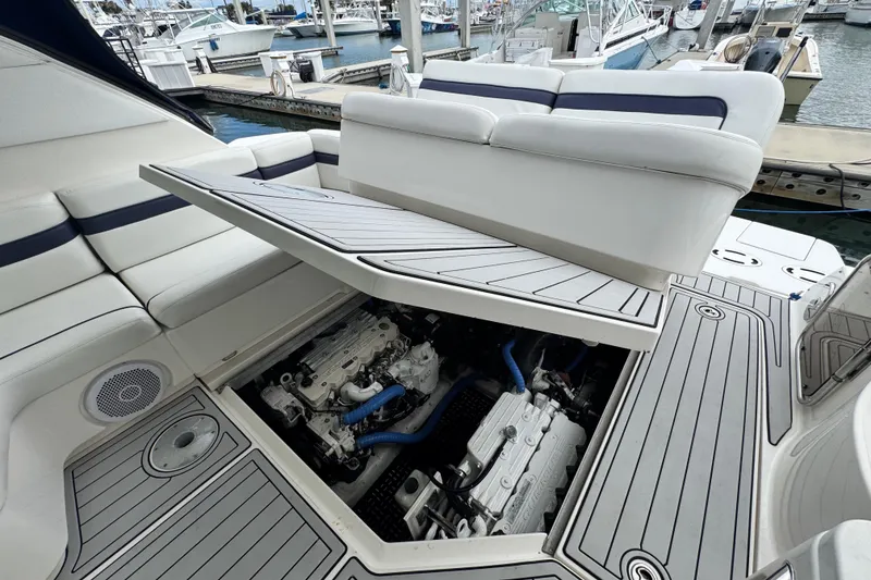 Slide: The Image of 2009 Sea Ray 470 Sundancer engine compartment with open hatch, docked at marina. - 15