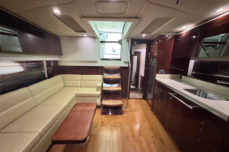 Slide: The Image of Luxurious interior of 2009 Sea Ray 470 Sundancer yacht with modern kitchen and seating area. - 17