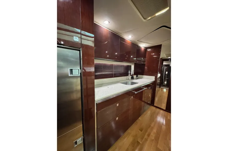 Slide: The Image of Luxurious kitchen interior of 2009 Sea Ray 470 Sundancer yacht with sleek cabinetry. - 20