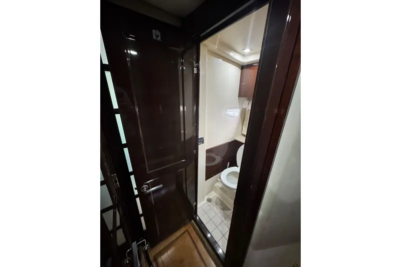 Slide: The Image of Bathroom interior of 2009 Sea Ray 470 Sundancer yacht, featuring modern fixtures and wood accents. - 27