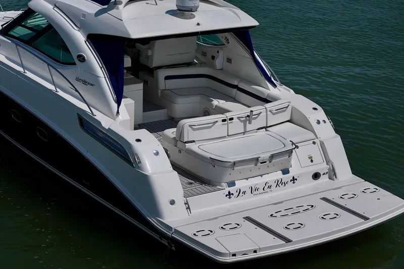 Slide: The Image of 2009 Sea Ray 470 Sundancer yacht on water, featuring spacious deck and elegant design. - 3