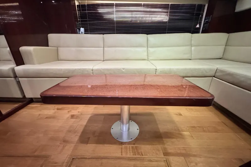 Slide: The Image of Luxurious interior of 2009 Sea Ray 470 Sundancer with beige seating and wooden table. - 35