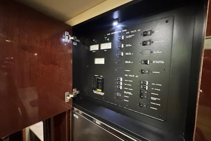 Slide: The Image of Electrical panel inside 2009 Sea Ray 470 Sundancer yacht, featuring various switches and controls. - 38