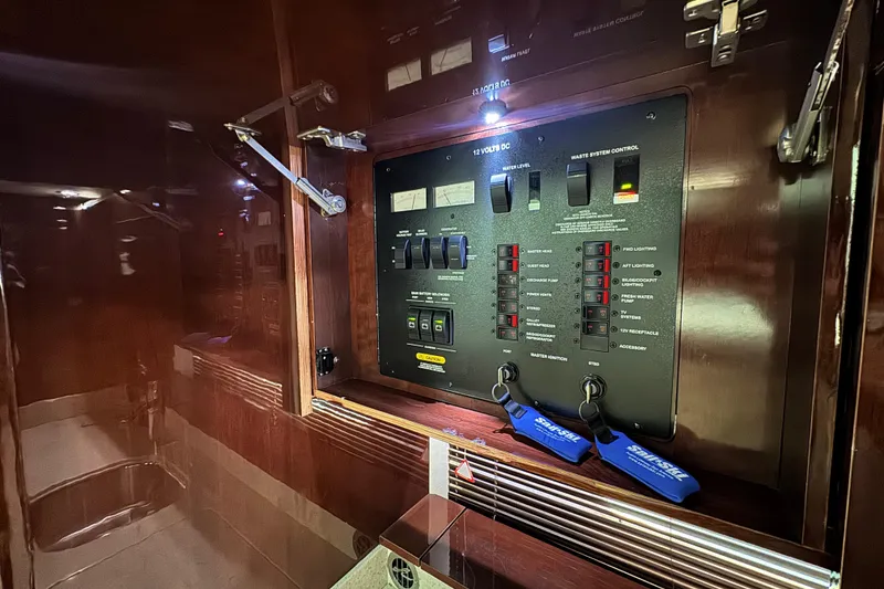 Slide: The Image of Electrical control panel inside 2009 Sea Ray 470 Sundancer yacht, featuring switches and indicators. - 39