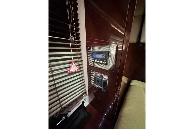 Slide: The Image of Interior of 2009 Sea Ray 470 Sundancer with control panel and blinds. - 41