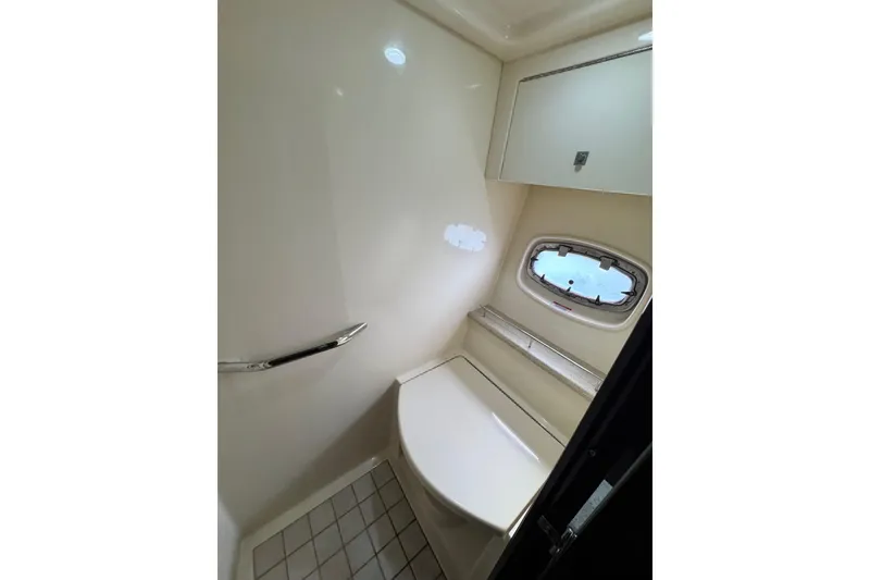 Slide: The Image of Bathroom interior of 2009 Sea Ray 470 Sundancer yacht, featuring a window and sleek design. - 47