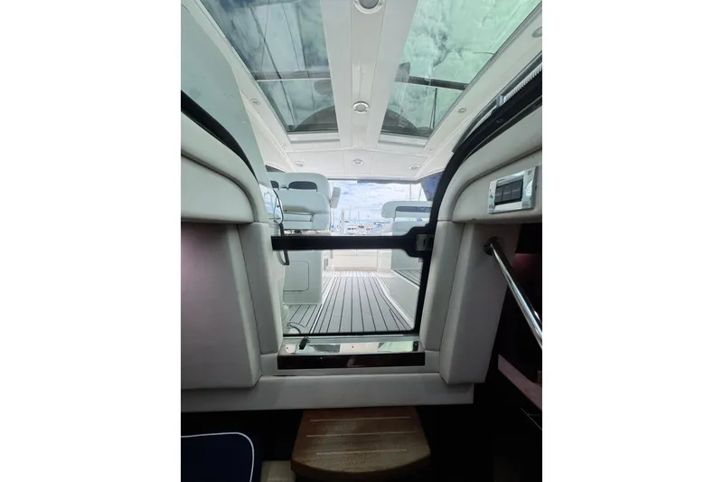 Slide: The Image of Interior view of 2009 Sea Ray 470 Sundancer yacht with open sunroof and seating area. - 53