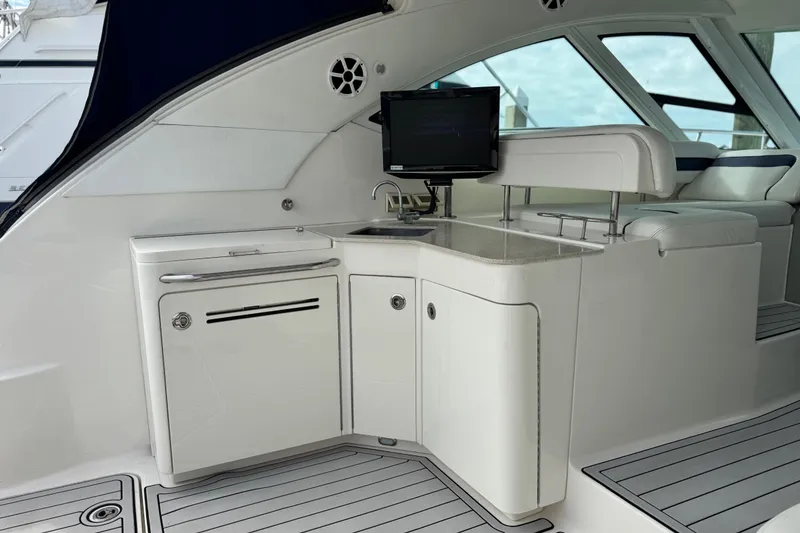 Slide: The Image of 2009 Sea Ray 470 Sundancer yacht interior with kitchenette and seating area. - 54