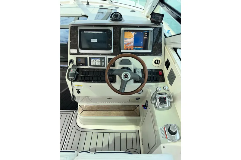 Slide: The Image of 2009 Sea Ray 470 Sundancer helm with navigation screens and controls. - 61