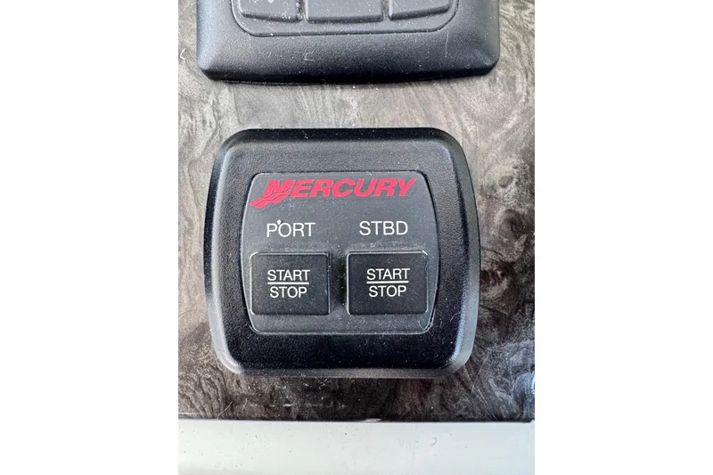 Slide: The Image of Mercury engine start-stop panel on 2009 Sea Ray 470 Sundancer boat dashboard. - 73