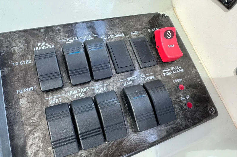 Slide: The Image of Control panel of a 2009 Sea Ray 470 Sundancer boat with various switches and indicators. - 74