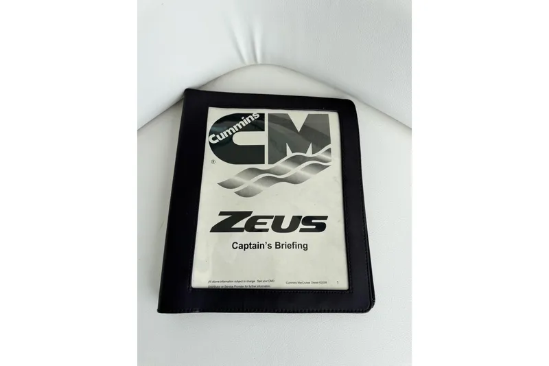 Slide: The Image of Cummins Zeus Captain's Briefing manual on white surface, related to 2009 Sea Ray 470 Sundancer. - 75
