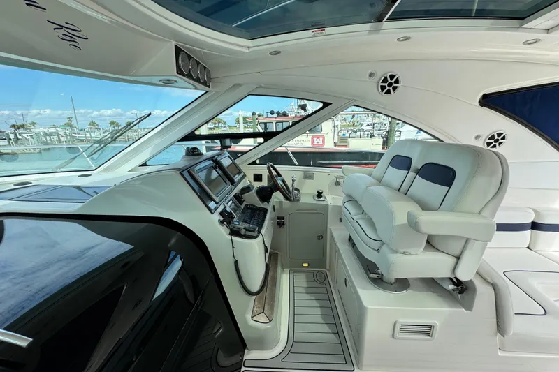 Slide: The Image of 2009 Sea Ray 470 Sundancer helm with modern controls and luxurious seating. - 79