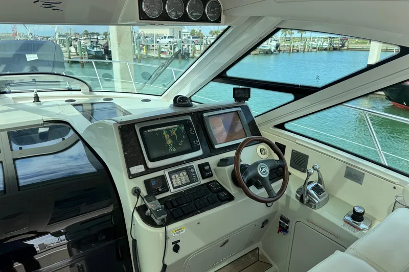 Slide: The Image of Interior helm of 2009 Sea Ray 470 Sundancer yacht with navigation equipment and steering wheel. - 83