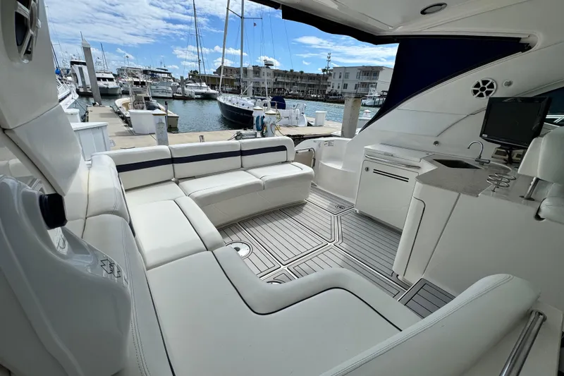 Slide: The Image of Luxurious 2009 Sea Ray 470 Sundancer yacht interior at marina, featuring elegant seating and amenities. - 86