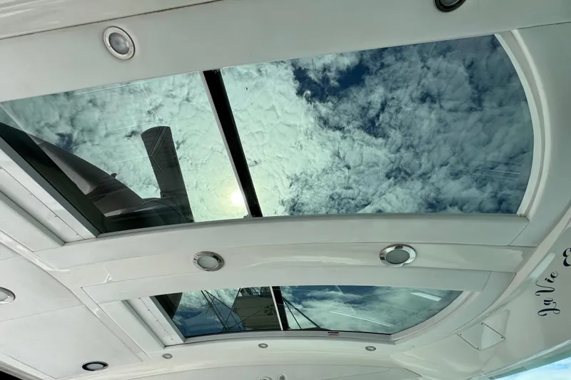 Slide: The Image of Sunroof view from 2009 Sea Ray 470 Sundancer, showcasing cloudy sky and sunlight. - 88
