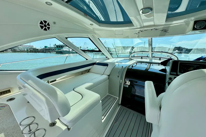 Slide: The Image of Interior of 2009 Sea Ray 470 Sundancer yacht with luxurious seating and panoramic windows. - 9