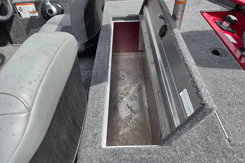 Slide: The Image of 2023 Tracker Pro 170 boat interior storage compartment with gray seating and carpeted flooring. - 10