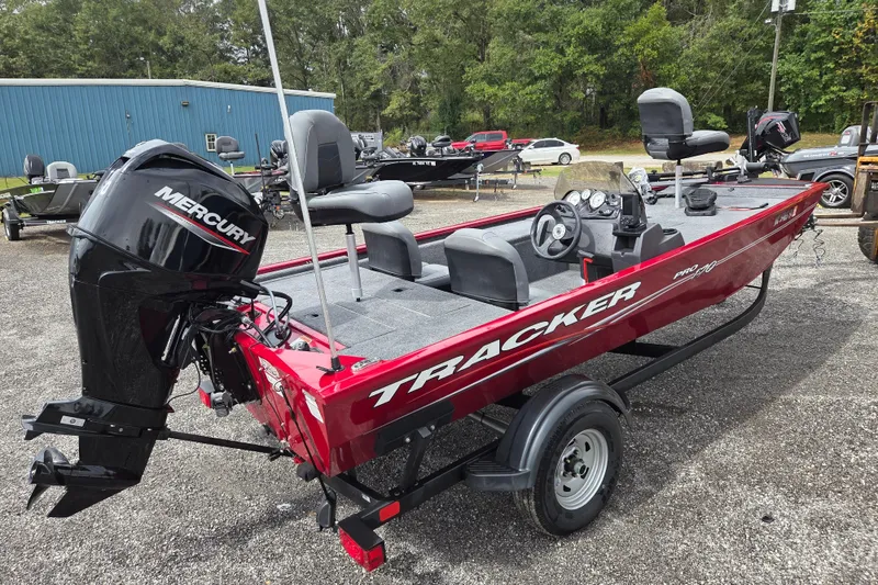 Slide: The Image of 2023 Tracker Pro 170 boat with Mercury engine, parked outdoors on a trailer. - 3