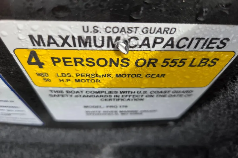 Slide: The Image of 2023 Tracker Pro 170 capacity label: 4 persons or 555 lbs, U.S. Coast Guard compliant. - 6