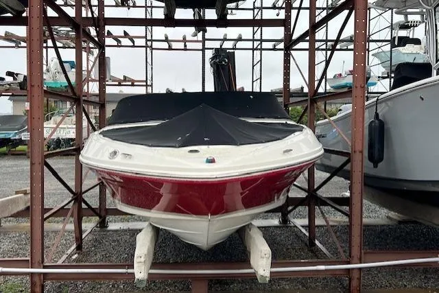 Slide: The Image of 2008 Sea Ray 205 Sport boat in storage, covered and elevated on a metal rack. - 1