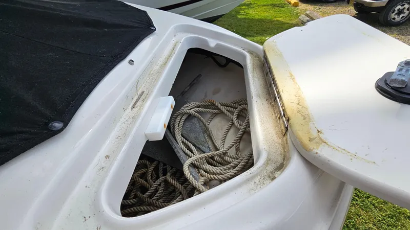 Slide: The Image of Open storage compartment on a 2008 Sea Ray 205 Sport boat with ropes inside. - 11