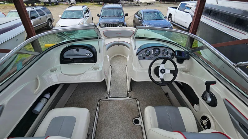 Slide: The Image of 2008 Sea Ray 205 Sport boat interior with dashboard and seating. - 13