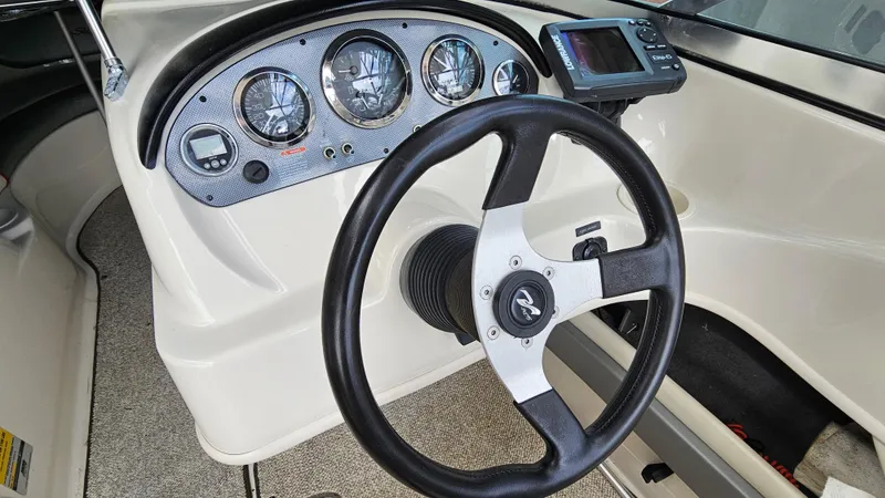 Slide: The Image of 2008 Sea Ray 205 Sport boat dashboard with steering wheel and instrument panel. - 14