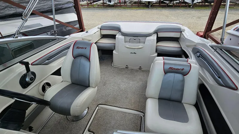 Slide: The Image of Interior of a 2008 Sea Ray 205 Sport boat with seating and steering wheel. - 18