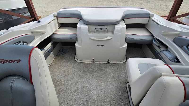 Slide: The Image of Interior of a 2008 Sea Ray 205 Sport boat with cushioned seating. - 21