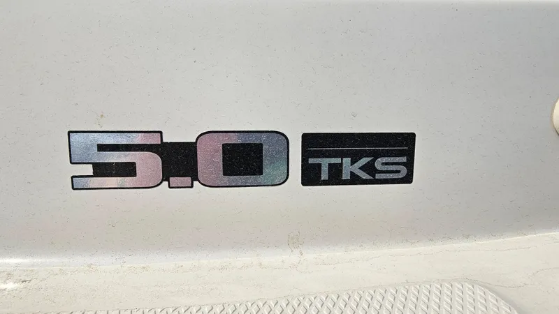 Slide: The Image of 5.0 TKS badge on a 2008 Sea Ray 205 Sport boat. - 27